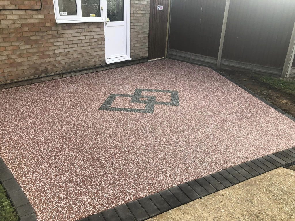 30 sq metre resin driveway in Terracotta Snow with Charcoal block edging and a centre double diamond design
